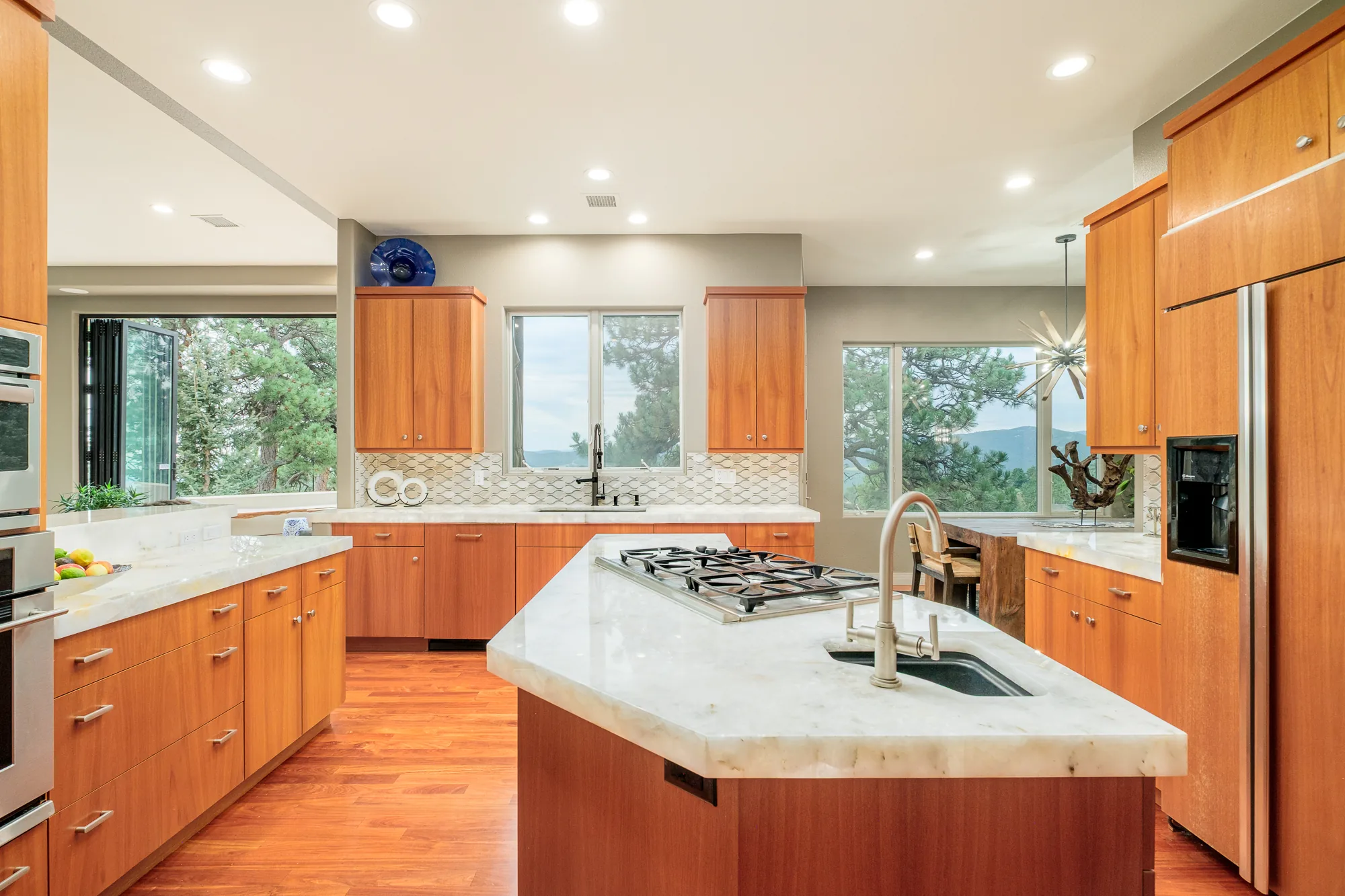Close view of the kitchen island and prep sink in marble.