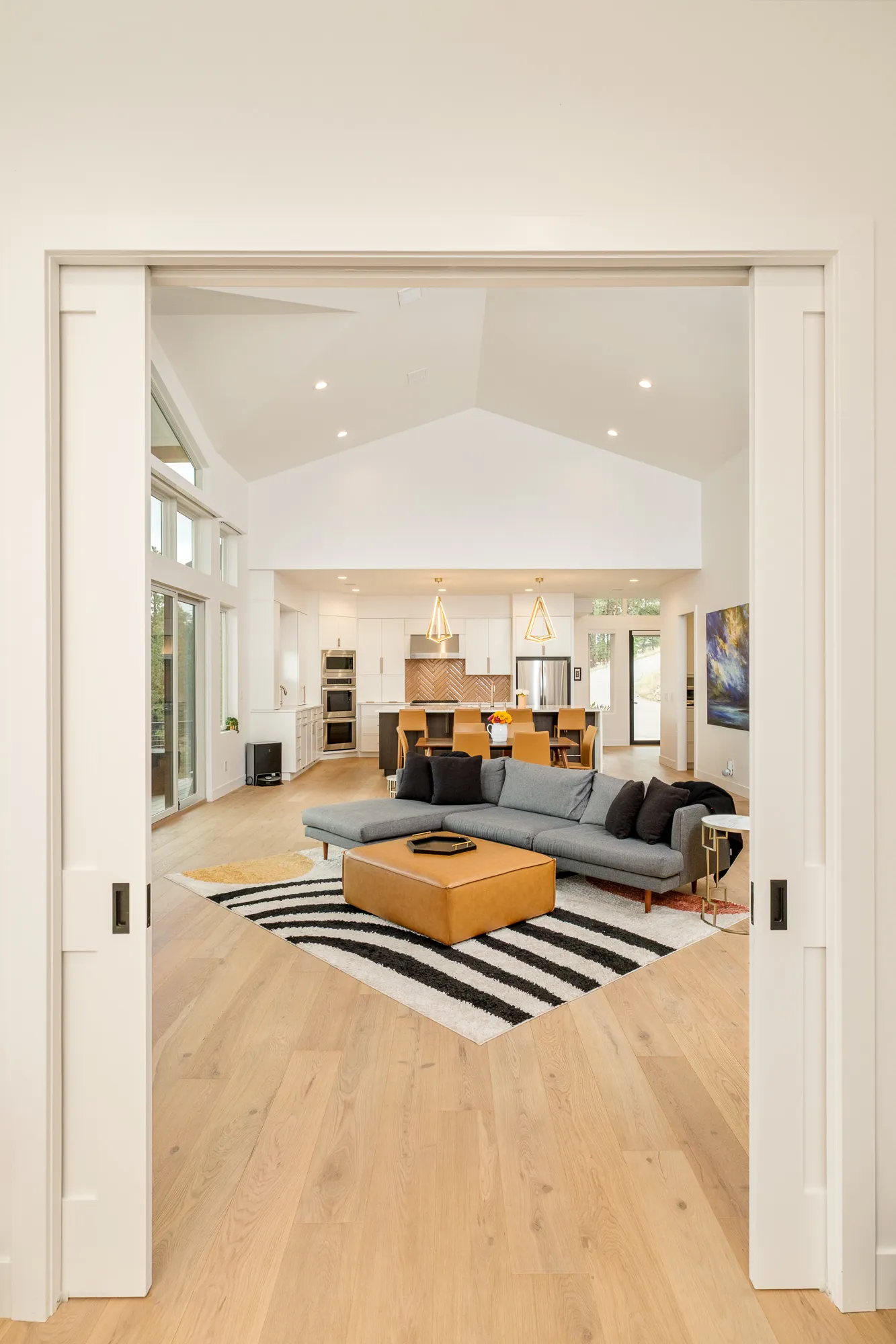 View through pocket doors into the great room and kitchen