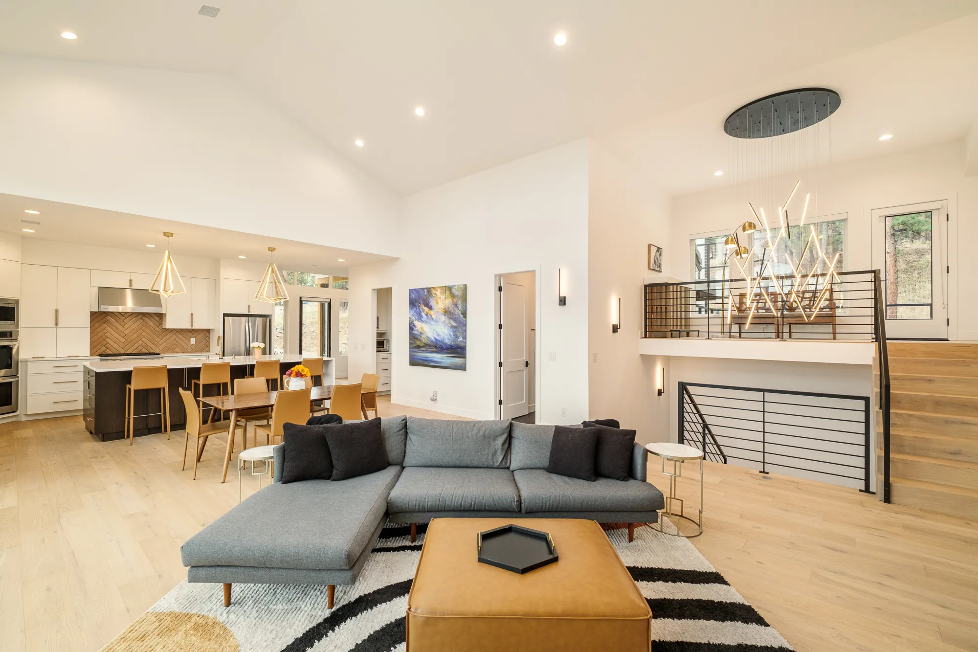 Living area beside an open stair with horizontal black railings