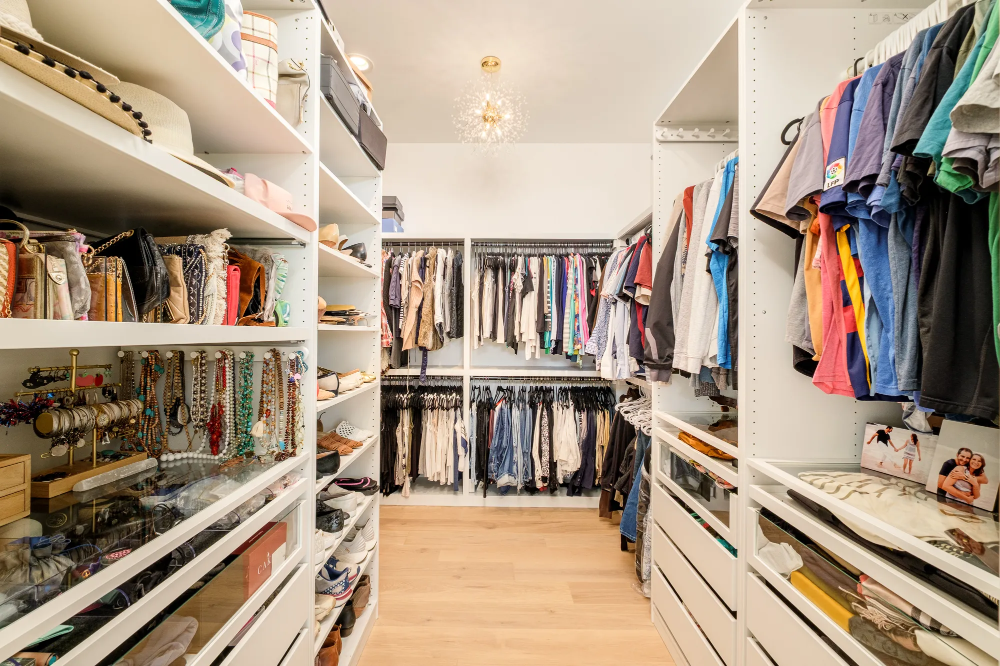 Walk-in closet with floor-to-ceiling shelving and drawers