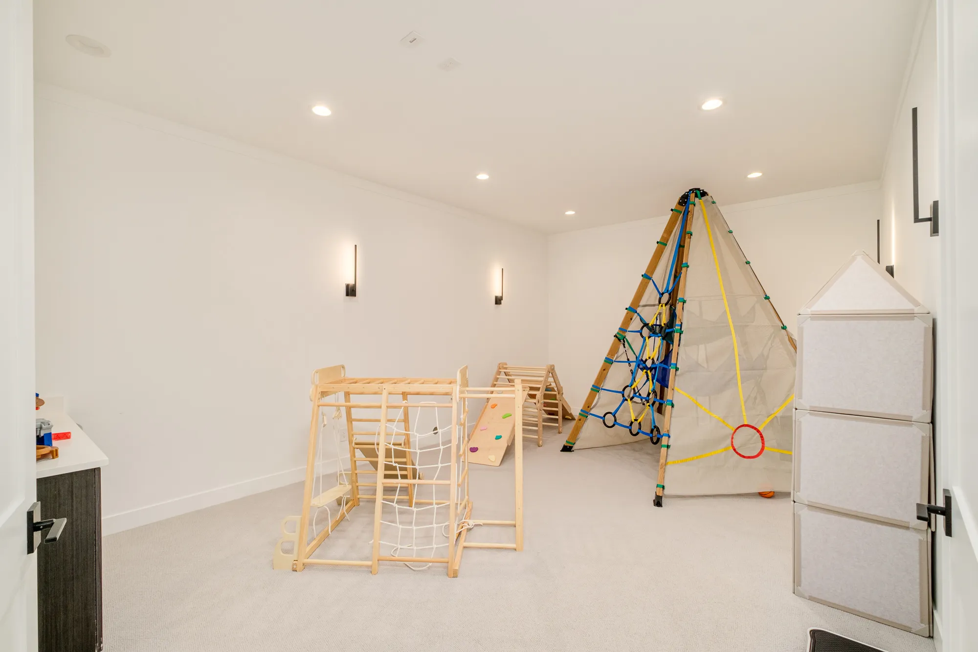 Lower-level play room with a climbing frame