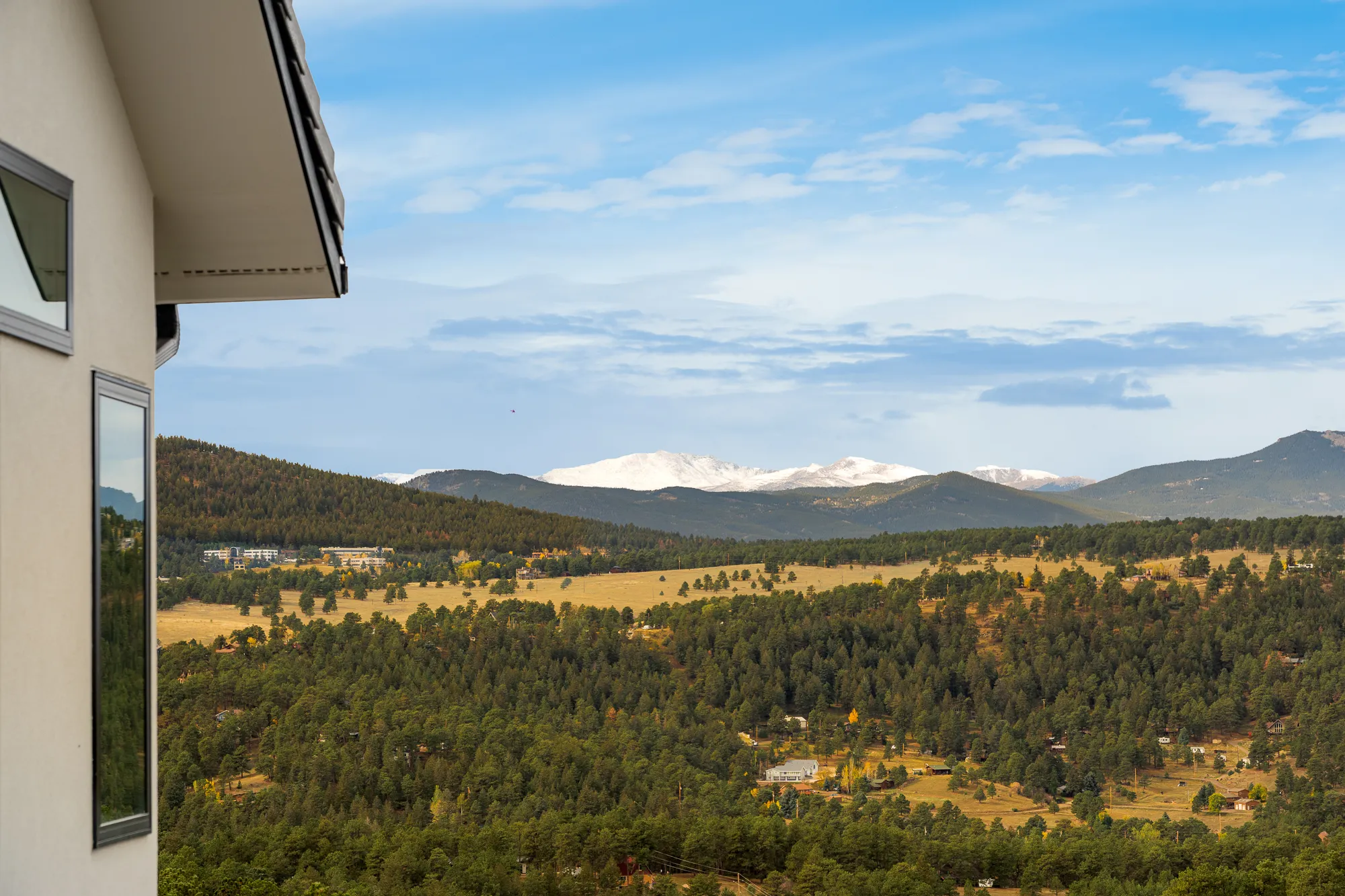 Foothills and distant snow-capped peaks from the side of the house